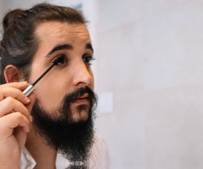 bearded individual wearing makeup